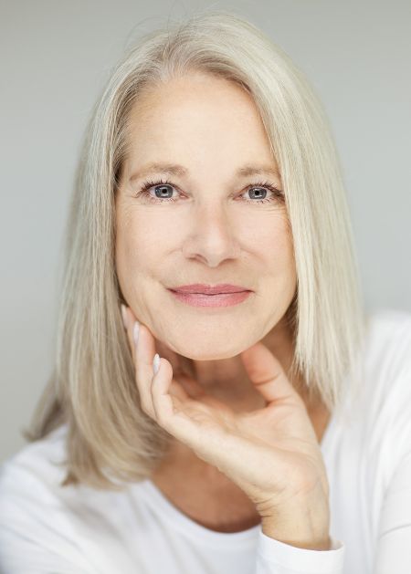 Smiling senior woman with rejuvenated face promoting Dermal filler injections in Salt Lake City